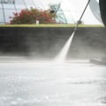 Are there any special considerations when using an adjustable water volume feature on a powerwasher?