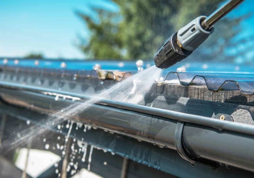 What do you spray on gutters before pressure washing?